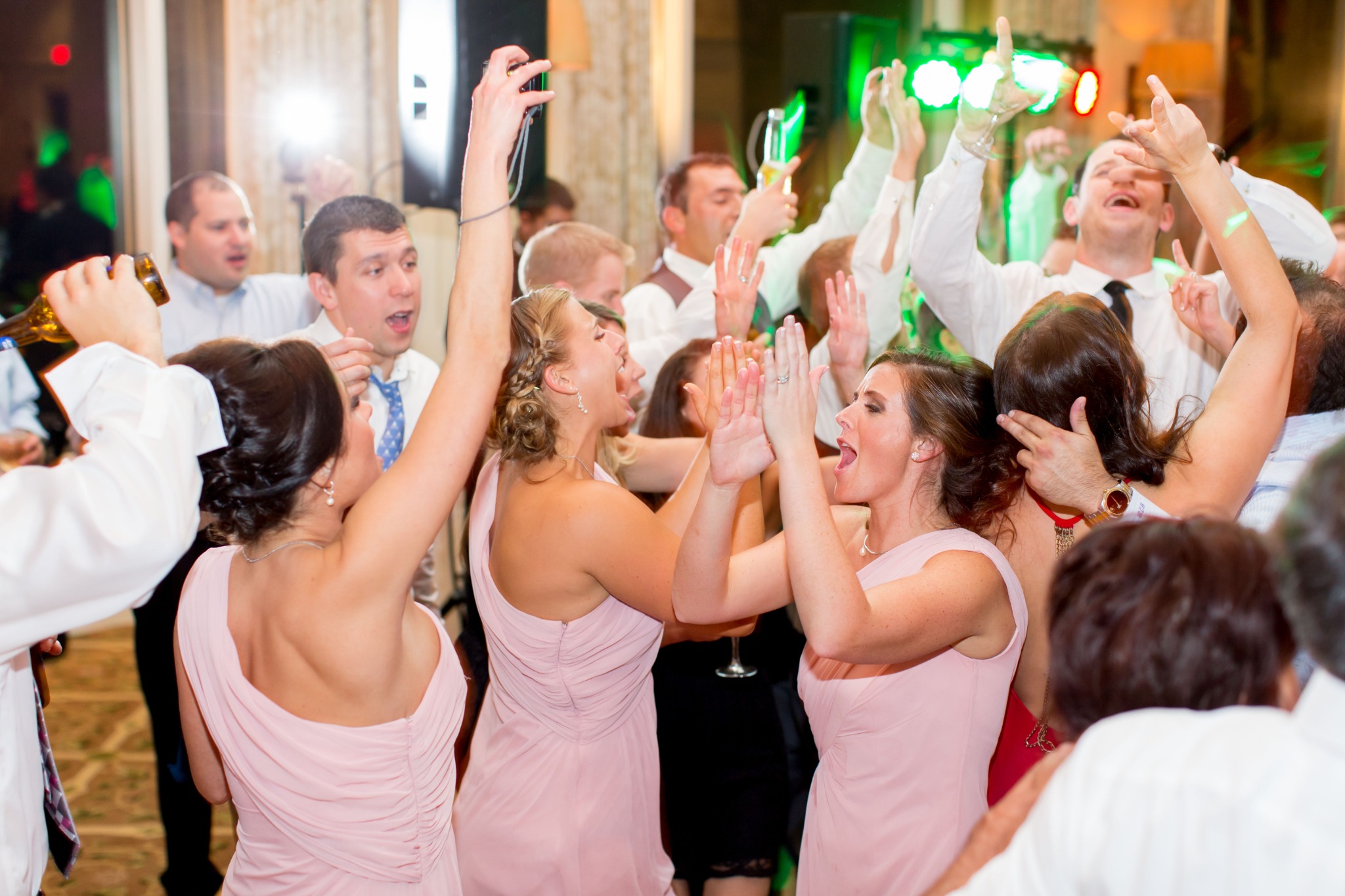 Wedding guests celebrating together on a packed dance floor