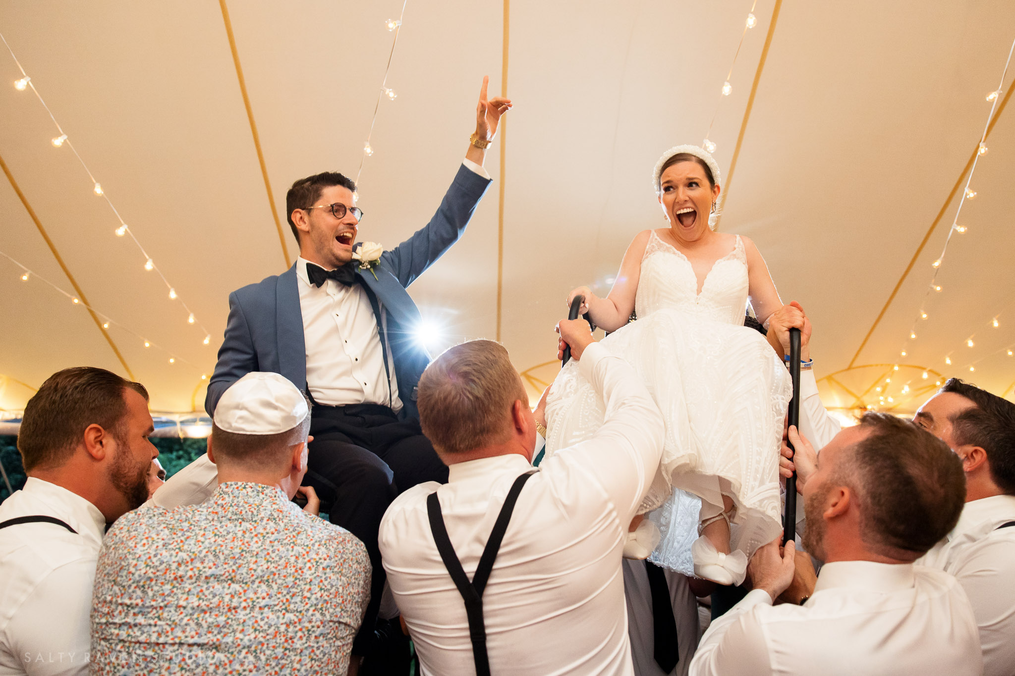 A Jewish couple celebrating high above their guests during the chair lift