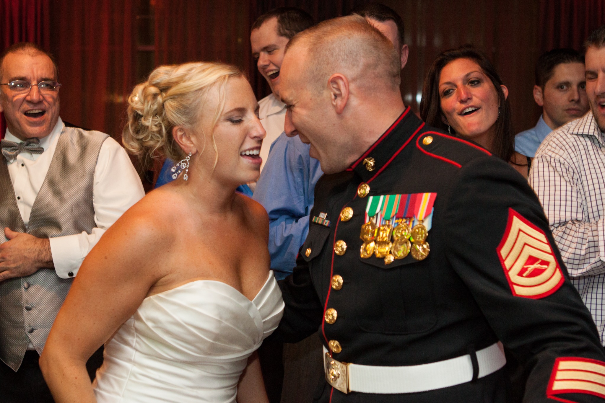 A newlywed couple celebrating together, with the groom wearing his Marine Corps dress uniform