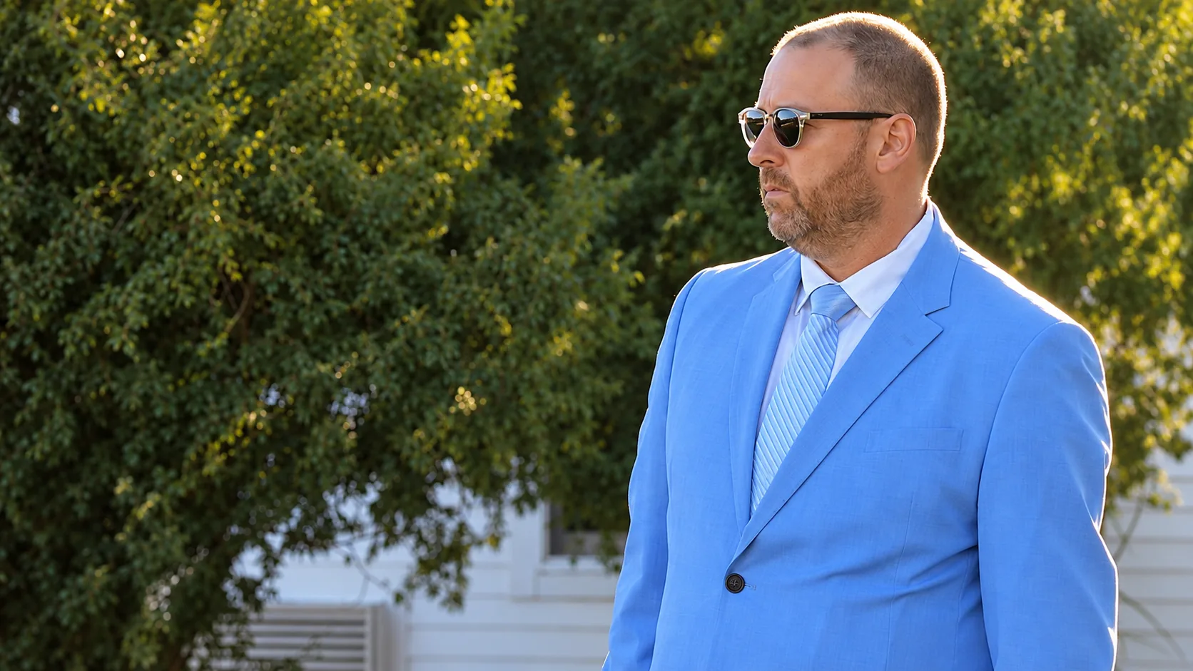 Sam Lurie in a blue suit outdoors, TSG Weddings DJ and wedding host
